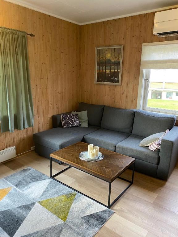 a living room with a couch and a coffee table at Høgtun kulturklynge in Olsborg