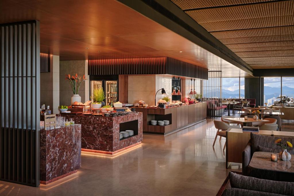 A marble-accented dining room includes buffet counters, window seating, and a city outlook.