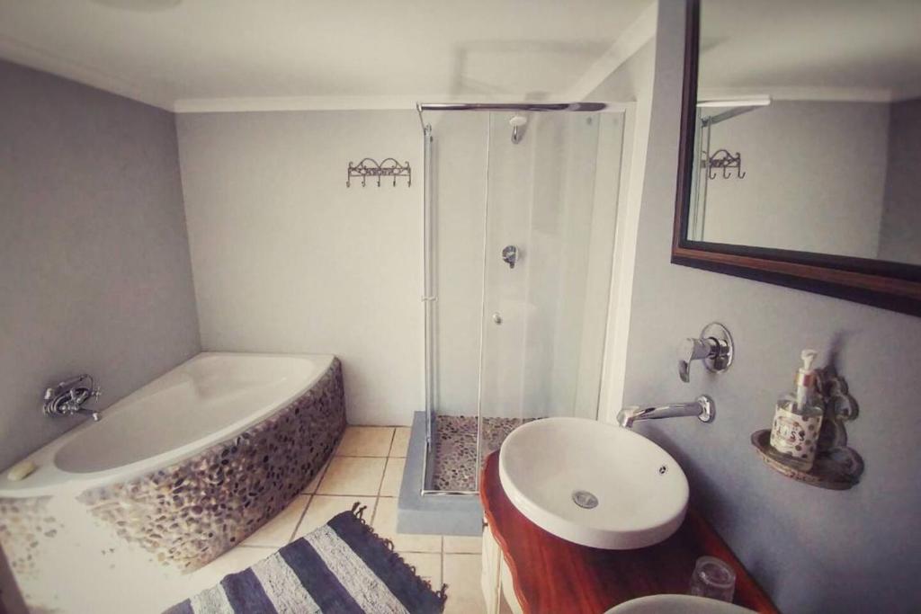 a bathroom with a shower and a tub and a sink at Bezalel Estate Country House 