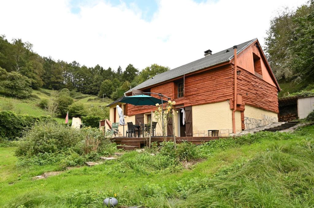 a wooden house on a hill in a field at Sport et réconfort en Couserans in Soulan