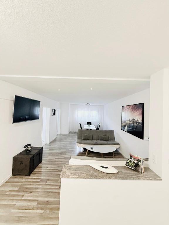 a white living room with a couch and a table at Ferienwohnung Hecker in Rastatt