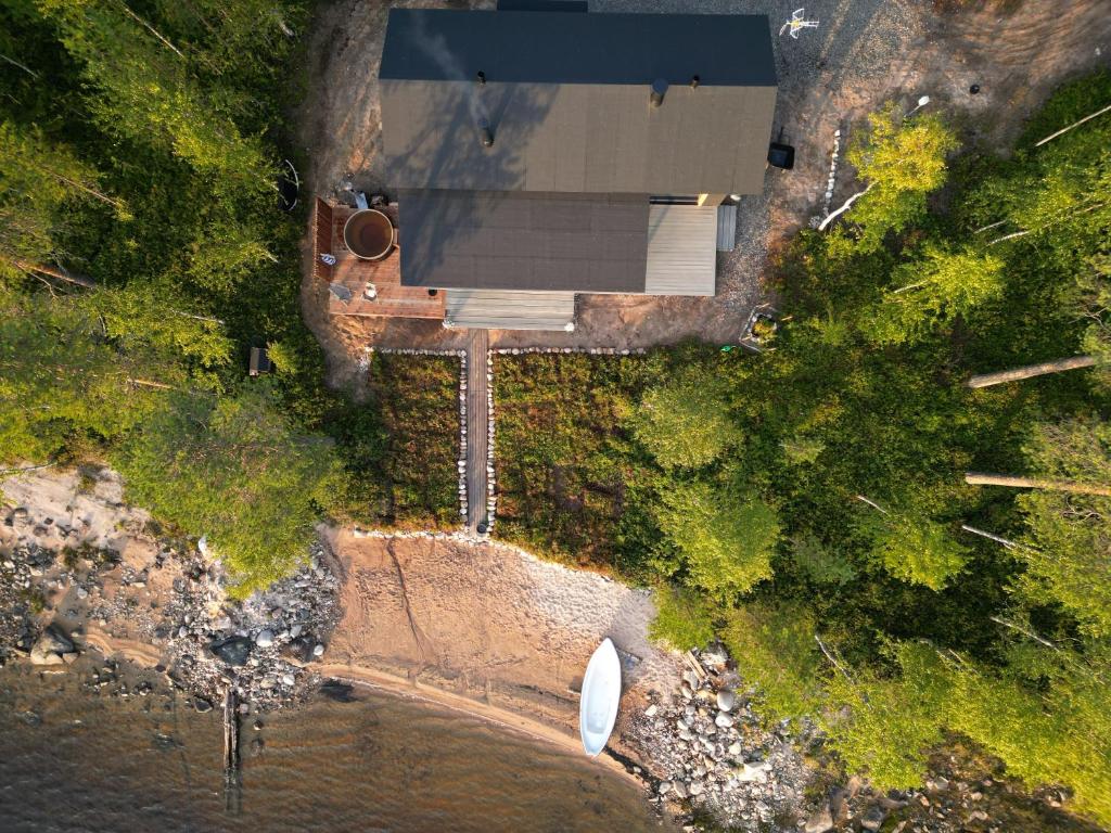 an overhead view of a house and a boat in the water at Kettula Getaway - Sauna Cabin in Suomussalmi