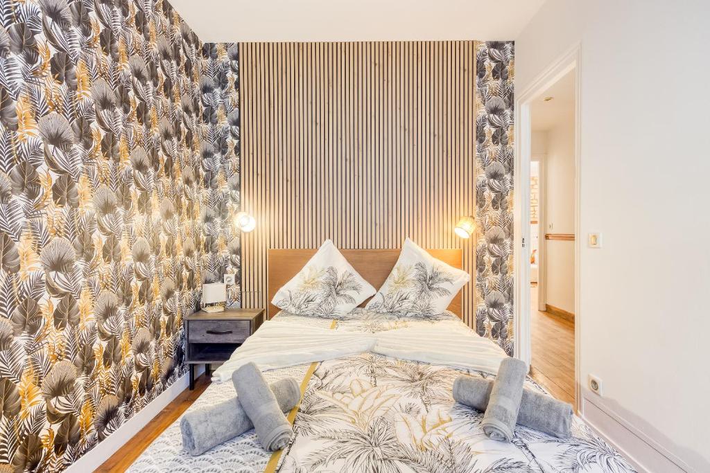 a bedroom with a large bed with a large wall at Le Saint Mandé - Aux Portes de Paris & Vincennes in Saint-Mandé