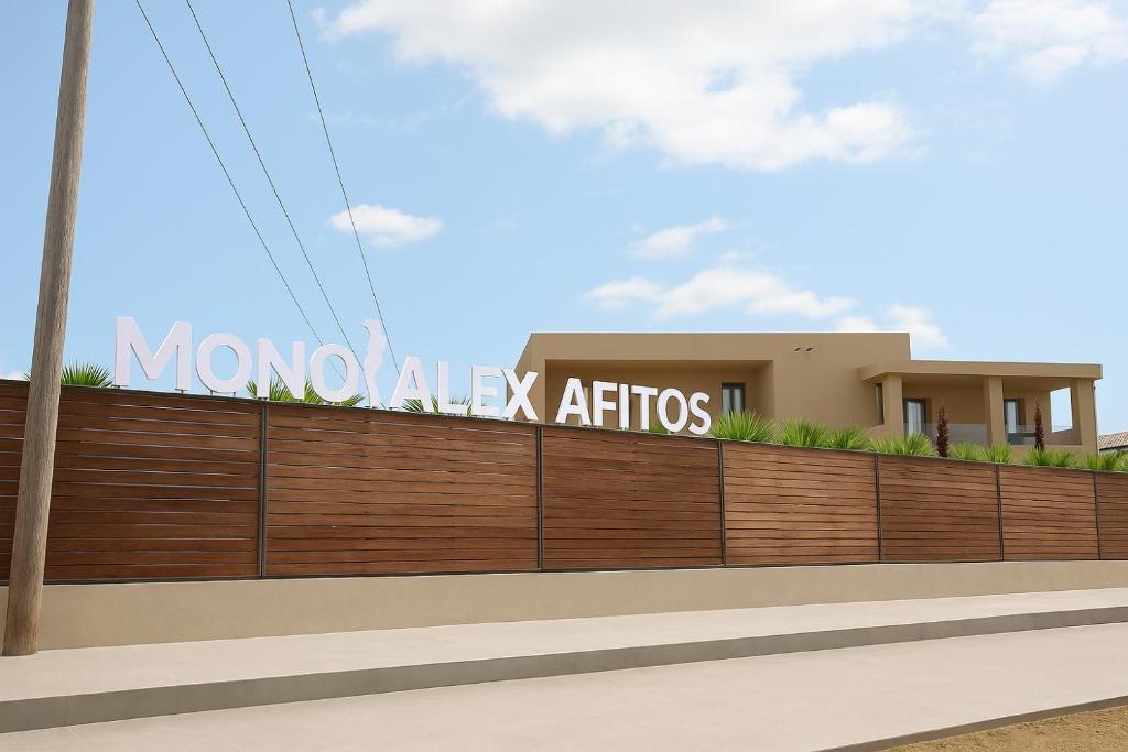 a house with a sign on a fence at Mono Alex Afitos in Afitos