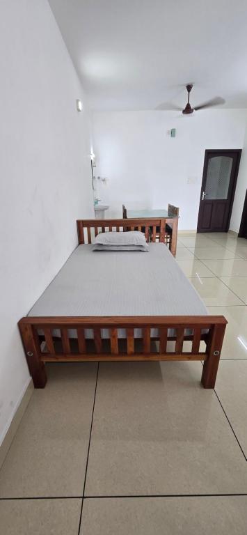ein Holzbett in einem Zimmer mit in der Unterkunft 2 bhk apartment near Aster medcity Kochi in Ernakulam