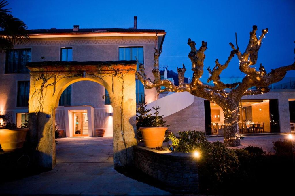 a house with a tree in front of it at night at Giardino Lago Bed&Breakfast in Minusio