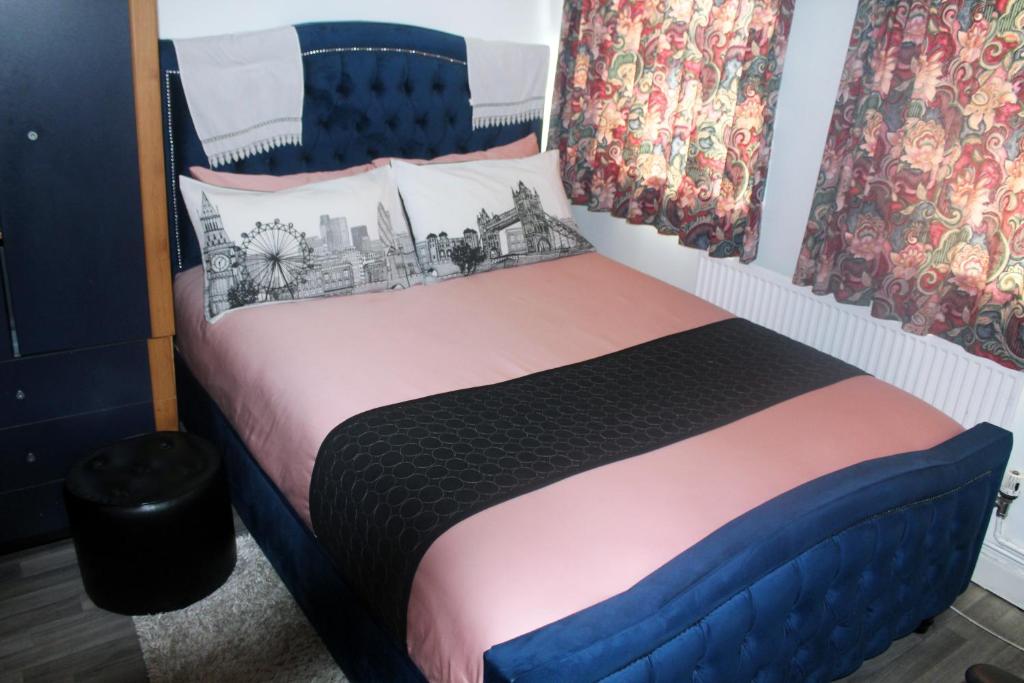 a bedroom with a bed with a blue headboard at Central London rooms in London