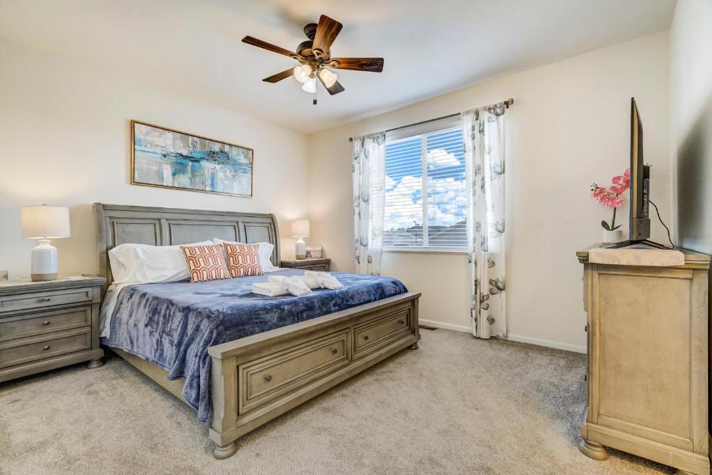 a bedroom with a bed and a ceiling fan at The Cozy Oak - Main Level Comforts in Fountain