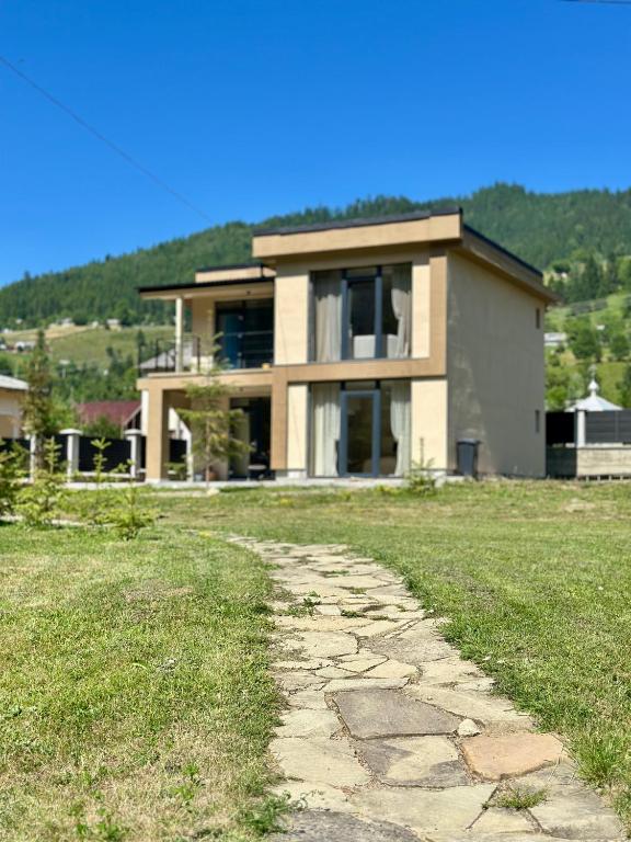 a house with a stone path in front of it at KalyNove апартаменти in Verkhniy Yasenov