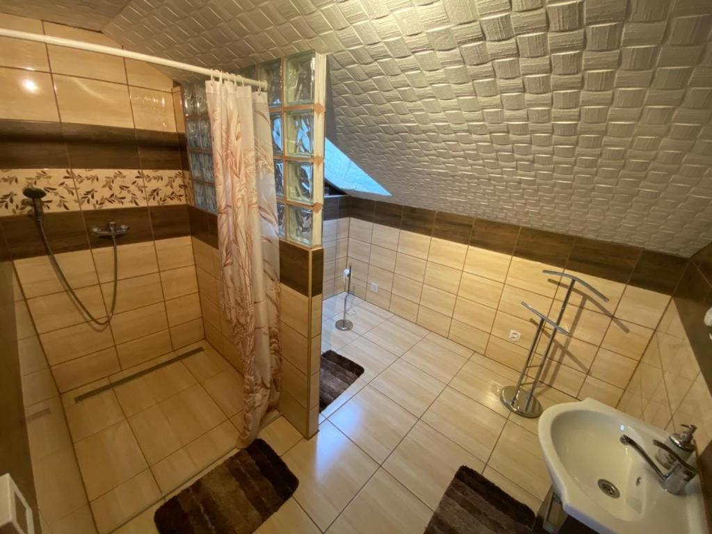 a bathroom with a shower and a sink at Chata u Strýčka in Dolný Kubín