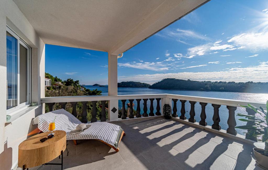 a balcony with a table and a view of the water at Apartment Karbuni Royal by Villas Guide in Brnistrova