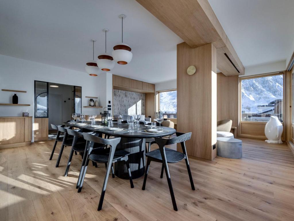 a large dining room with a table and chairs at Appartement rénové, lumineux avec terrasse, à deux pas des pistes à Tignes le Lac - FR-1-641-11 in Tignes