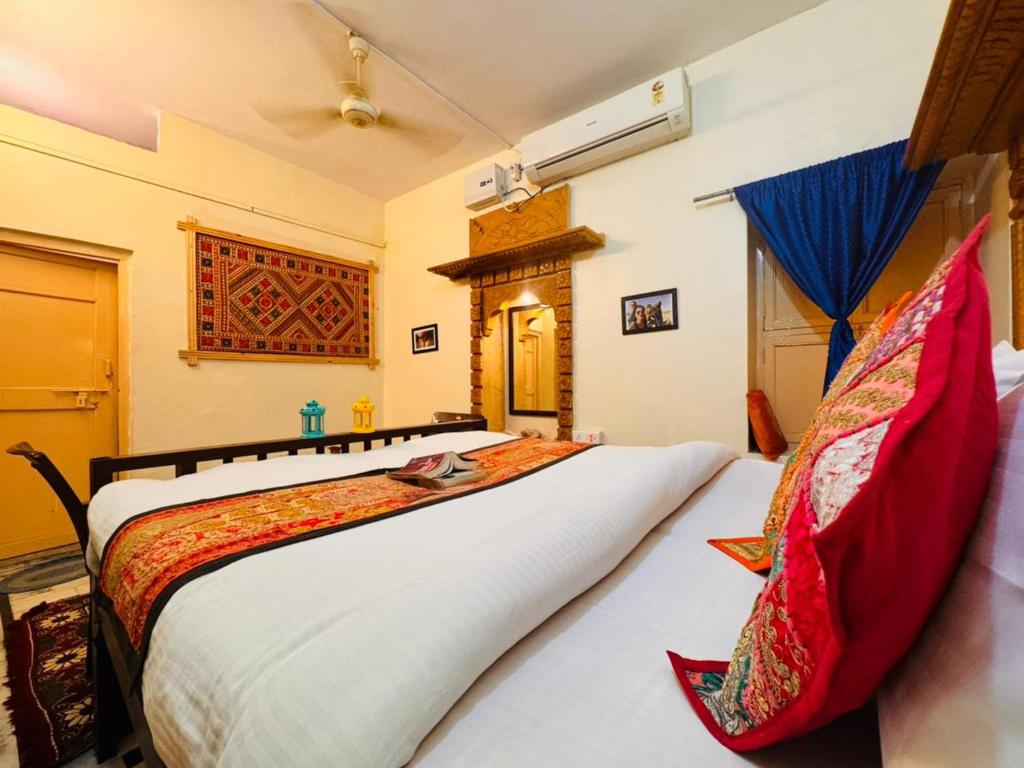 a bedroom with a large bed in a room at Heritage Haveli Jaisalmer in Jaisalmer