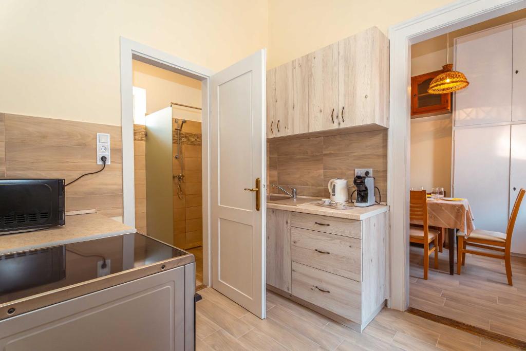 a small kitchen with a sink and a microwave at City apartman with piano in Keszthely