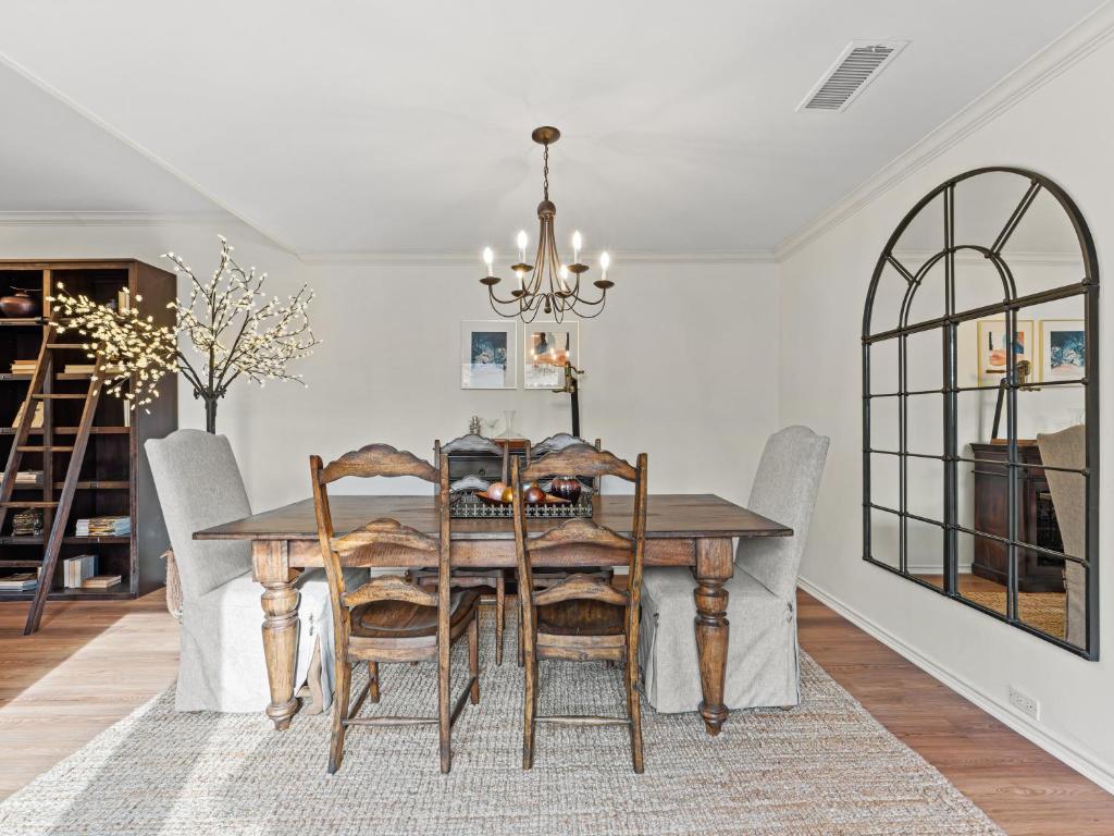 a dining room table with chairs and a chandelier at North Dallas Retreat - 3 BR - Spacious Backyard in Addison