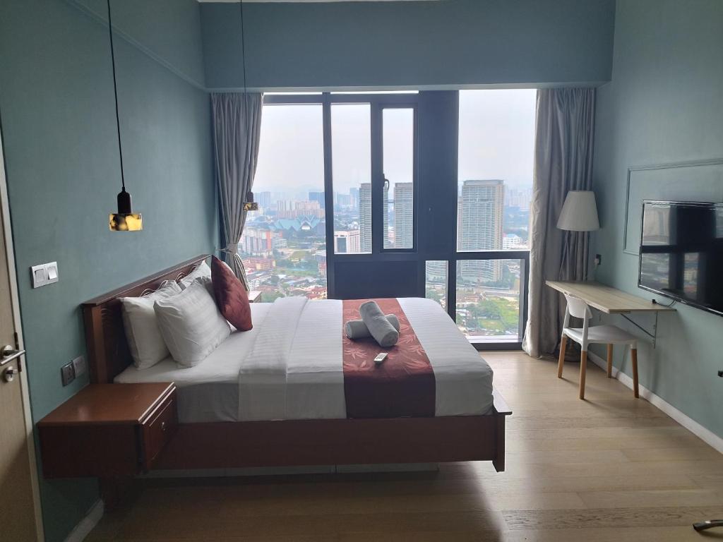 a bedroom with a bed and a large window at Casaluma STAR KLCC in Kuala Lumpur
