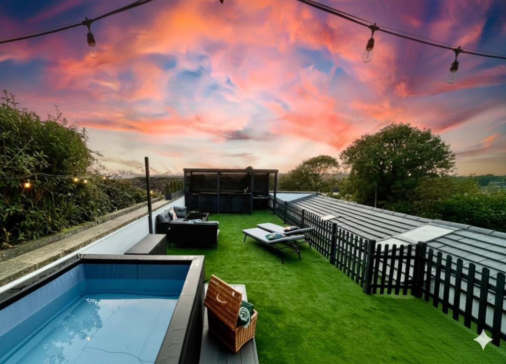 an outdoor patio with a pool and a sky at Elevated Escape in Seabrook