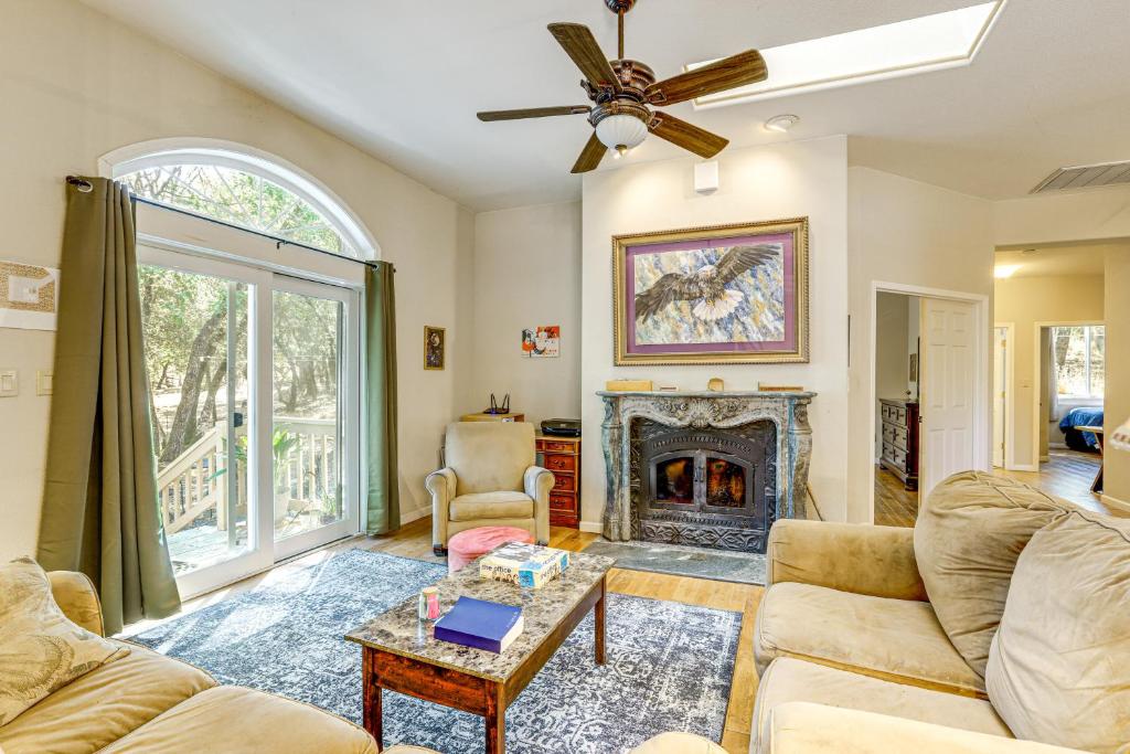 a living room with a couch and a fireplace at All-Season Outdoor Base Camp Gold Country Home! in Fiddletown