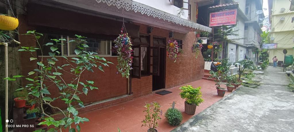 a brick building with plants on the side of it at SAI Guest House at Gangtok Taxi Stand in Gangtok