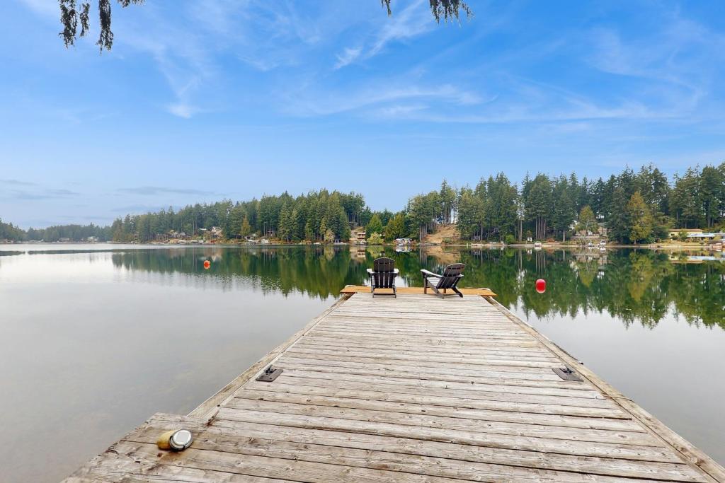 two chairs sitting on a dock on a lake at Phillips Lake Escape in Agate