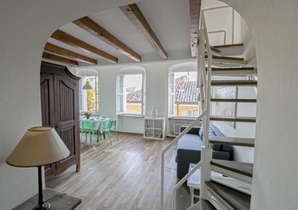 a bedroom with a bed and a staircase in a room at Penthouse in the center of Parma - bookable parking space in Parma