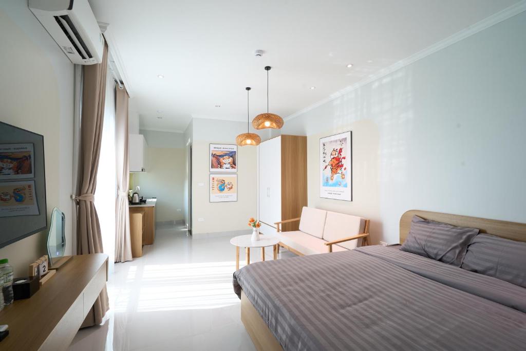 a bedroom with a bed and a table in it at Hanique Cafe and Stay in Hanoi