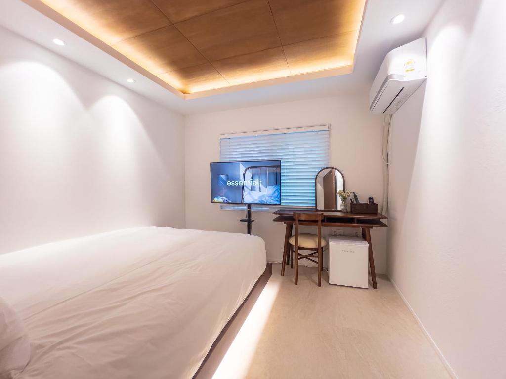 a bedroom with a bed and a desk and a television at 하루재 in Seoul