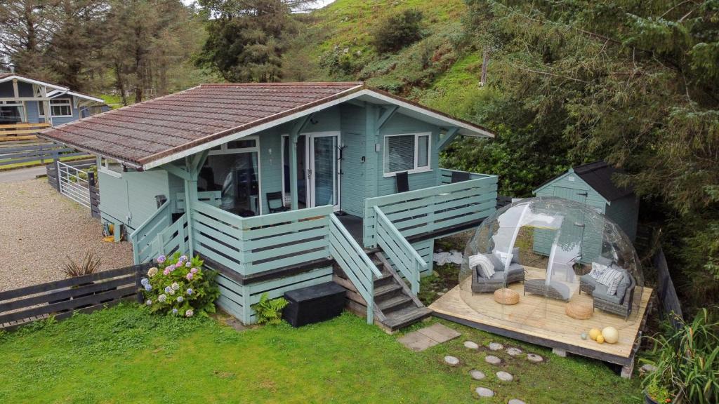 a small blue house with a domineering at Scarba in Balvicar