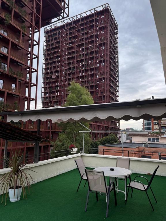 a table and chairs on the roof of a building at Hana Apartments TIRANA in Tirana