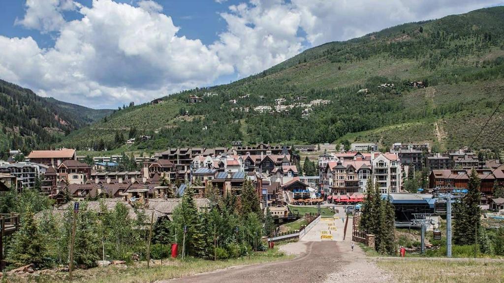 a town in the mountains with houses and trees at Alpenzauber Lodge in Vail