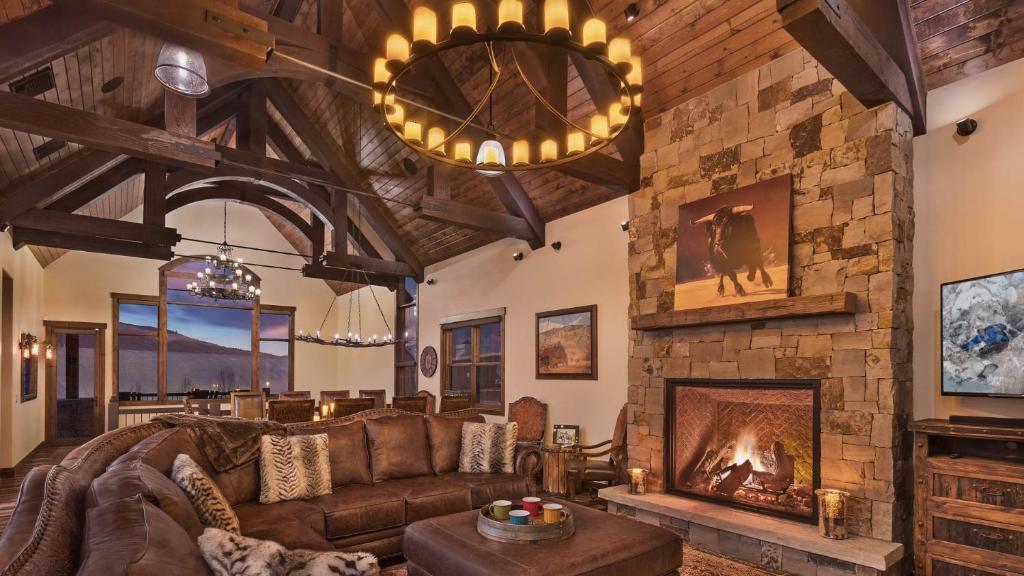 a living room with a couch and a fireplace at Appaloosa Mountain Lodge in Steamboat Springs