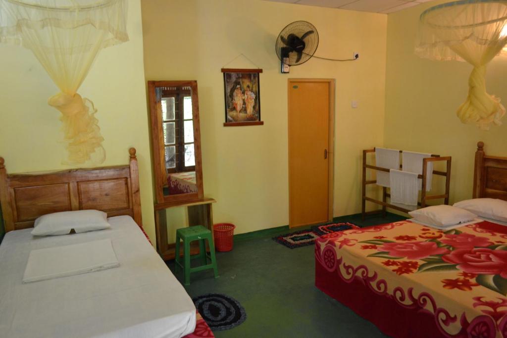 Postel nebo postele na pokoji v ubytování Sigiriya Freedom Lodge