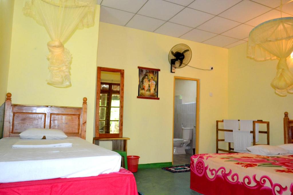 Postel nebo postele na pokoji v ubytování Sigiriya Freedom Lodge
