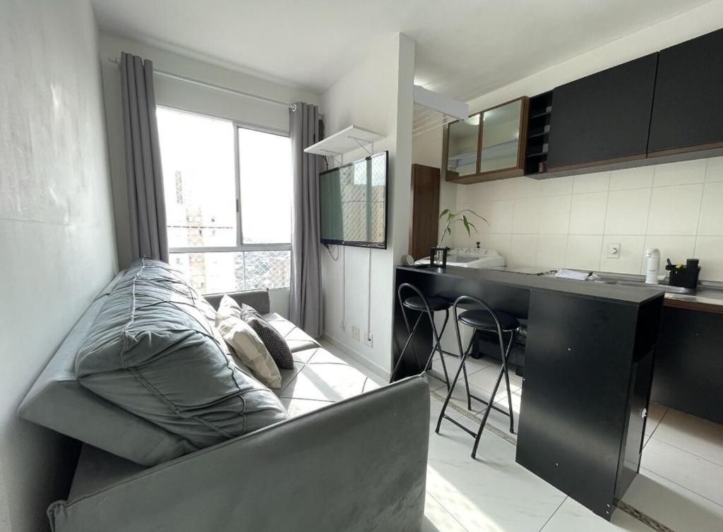 a living room with a couch and a kitchen at Apartment in Osasco in Osasco