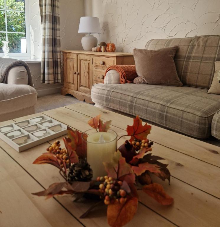 a living room with a coffee table and a couch at Riverside Cottage in Aycliffe