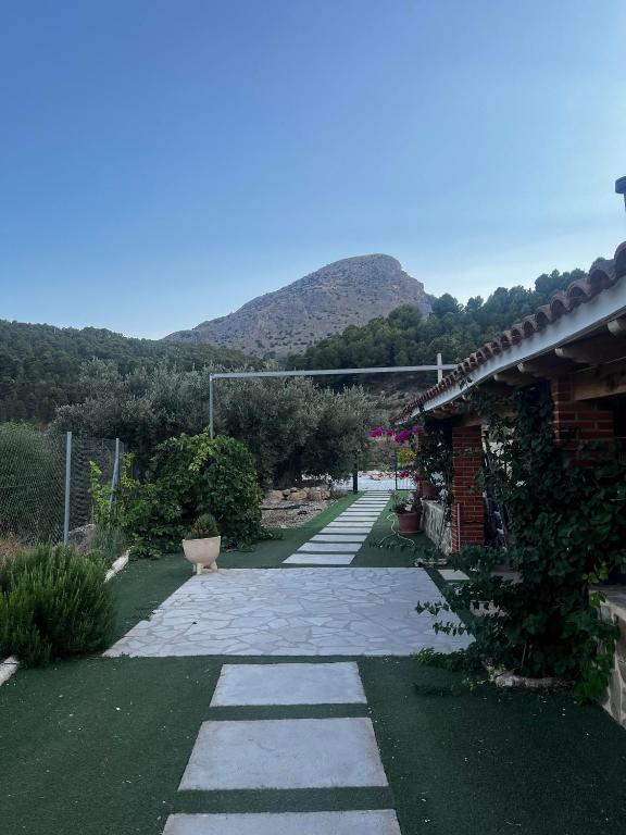 a garden with a stone walkway in front of a house at Cortijo Algüit in Vélez Blanco