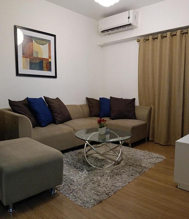 a living room with a couch and a table at Marquee Residences in Angeles