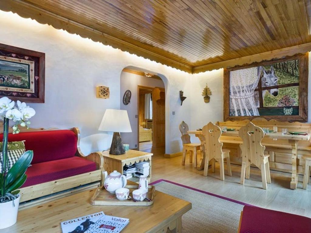 a living room with a red couch and a table at Grand appart familial 3 pièces près centre et pistes avec wifi - FR-1-575-161 in Courchevel