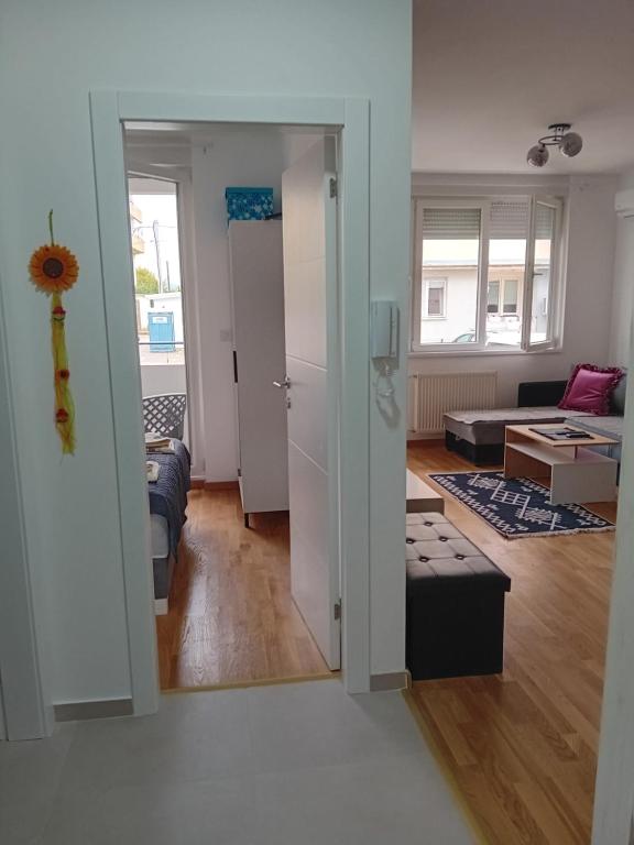 a living room with a door open to a living room at Suncokret in Kruševac