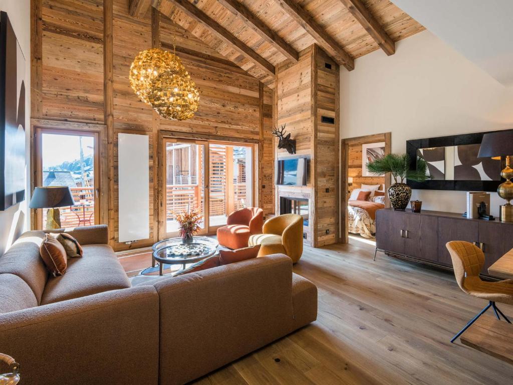 a living room with a couch and a table at Appartement de Luxe Neuf avec Terrasse au Cœur des Gets, Proche des Pistes et Commerces - FR-1-598-153 in Les Gets
