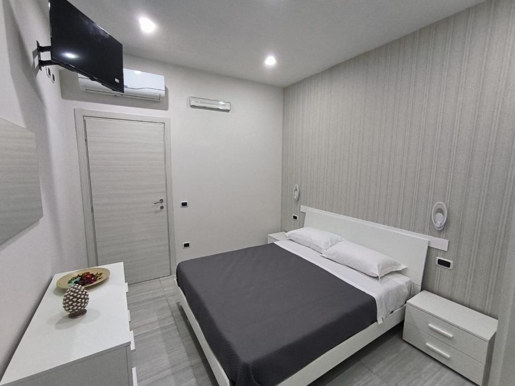 a small bedroom with a bed and a television at Five Street B&B in Nola