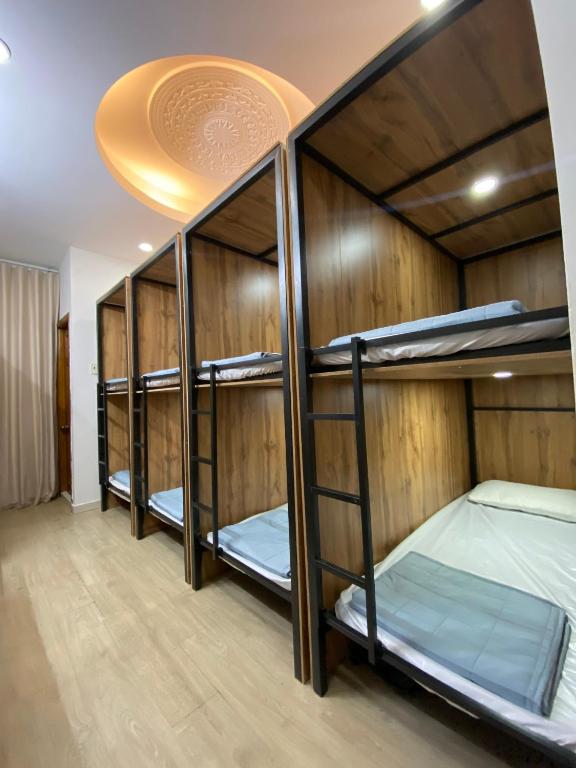 a room with four bunk beds with a ceiling at FUNNY Hostel & cafe in Ho Chi Minh City