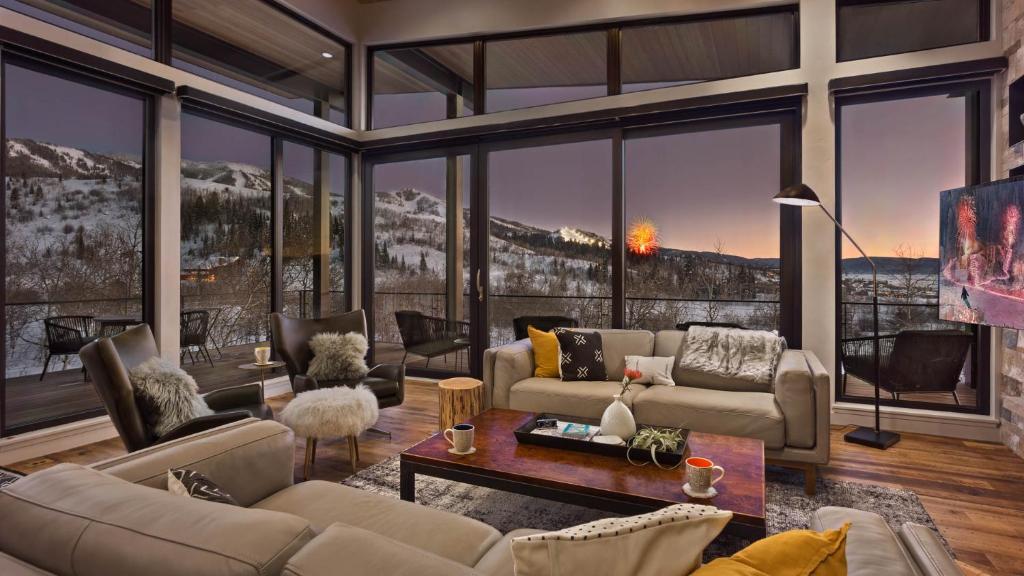 a living room filled with furniture and a large window at Chalet Cascada in Steamboat Springs