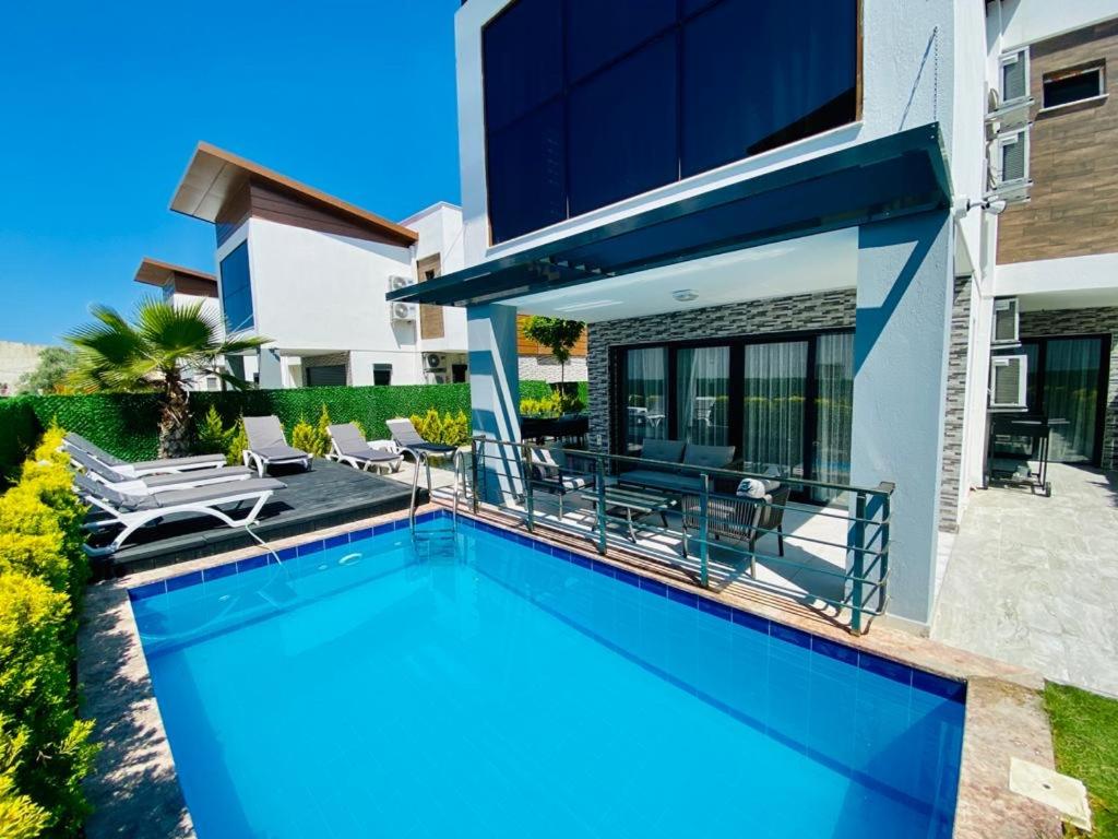 a swimming pool in the backyard of a house at Luxury villa Ada Marin in Kusadası