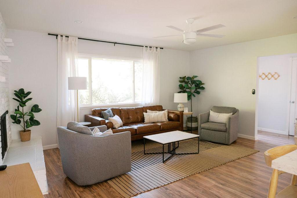 a living room with a couch and two chairs at Lake Park Landing in Atascadero