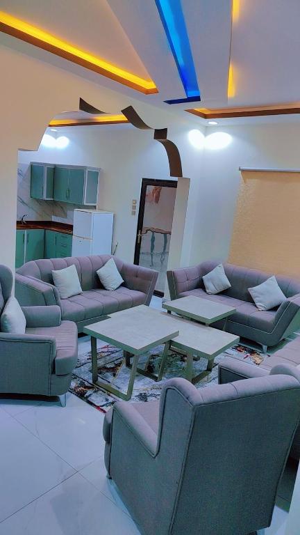 a living room with couches and tables in a room at منتجع سيتي لاند فله رقم 4 in Taif