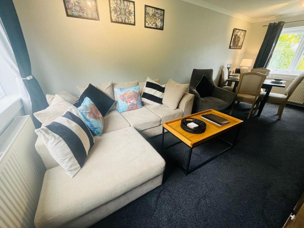 a living room with a white couch and a table at 4 Caledonian Road in Fort William