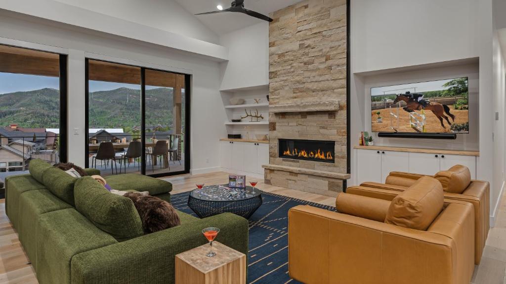 a living room with two couches and a fireplace at Friesian Chalet in Steamboat Springs