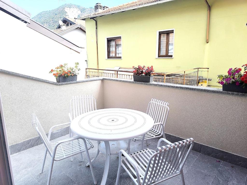 a patio with a table and chairs on a balcony at Eden Home just a few minutes from Lake Maggiore in Gravellona Toce