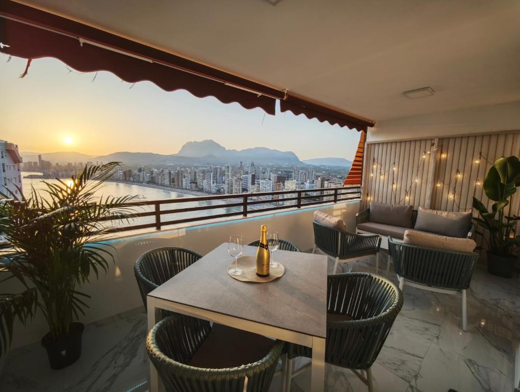 a table and chairs on a balcony with a view at Sea&Skyline Suites Benidorm in Benidorm